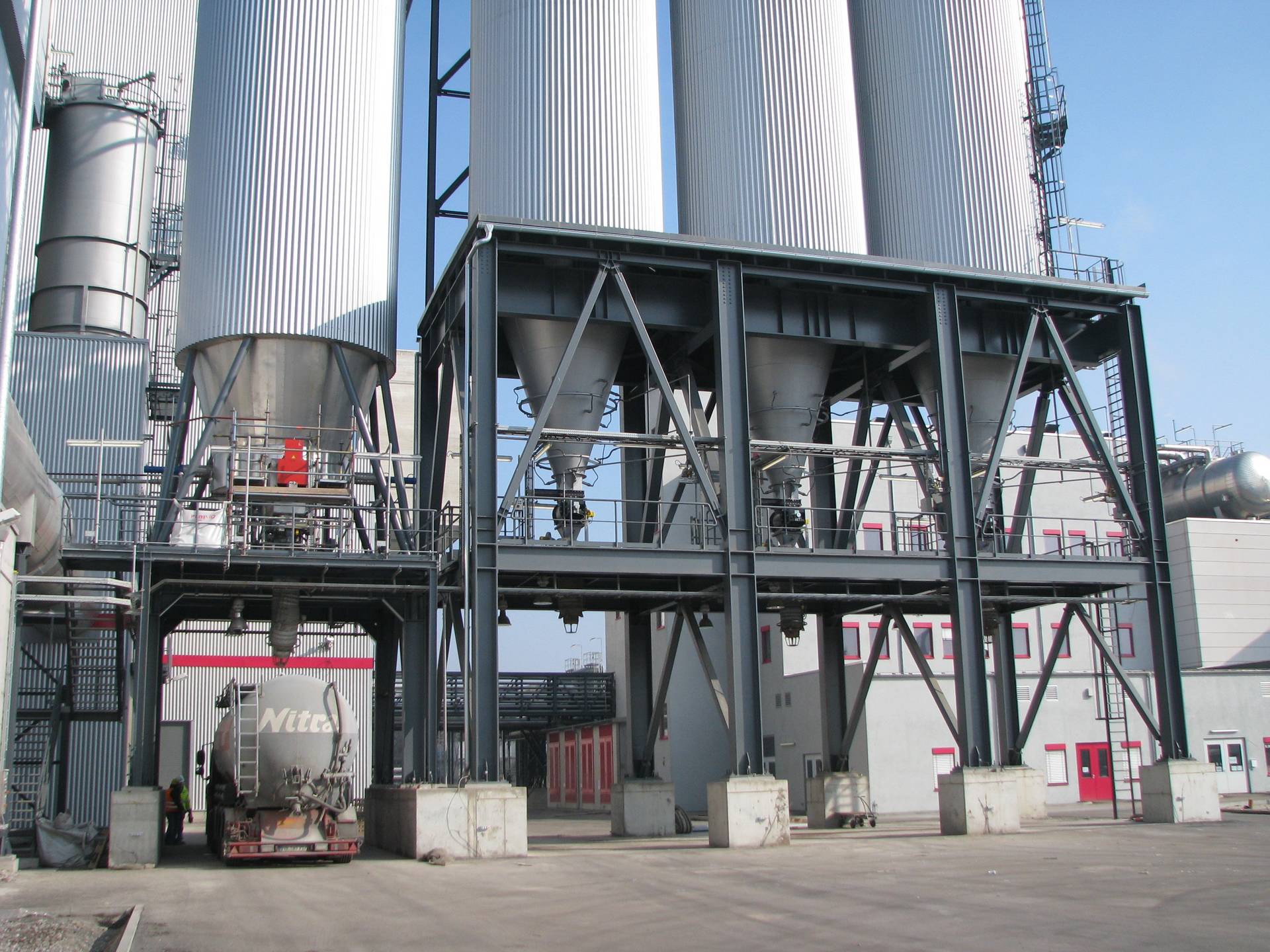 Reference photograph of industrial silos on braced structural-steel support frames